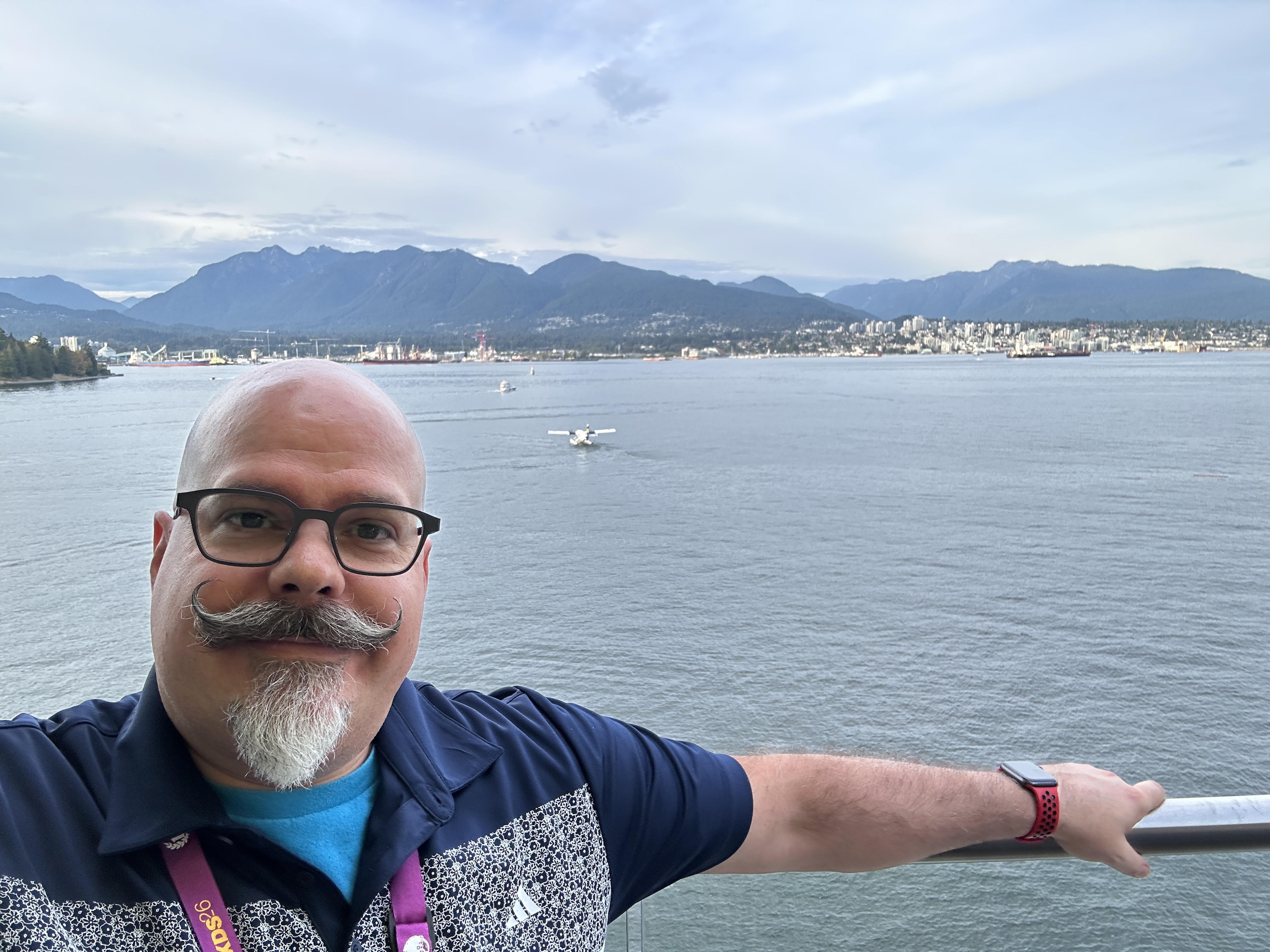 Fred by the waterfront in Vancouver, with mountains across the water.